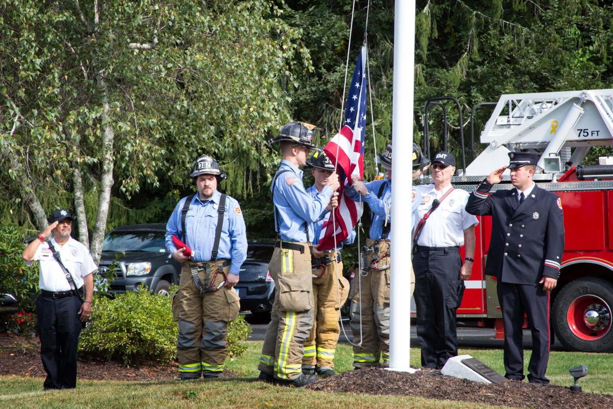 9/11/2016 Ceremony -  Firefighters in gear - some raising flag, some saluting, solemn faces