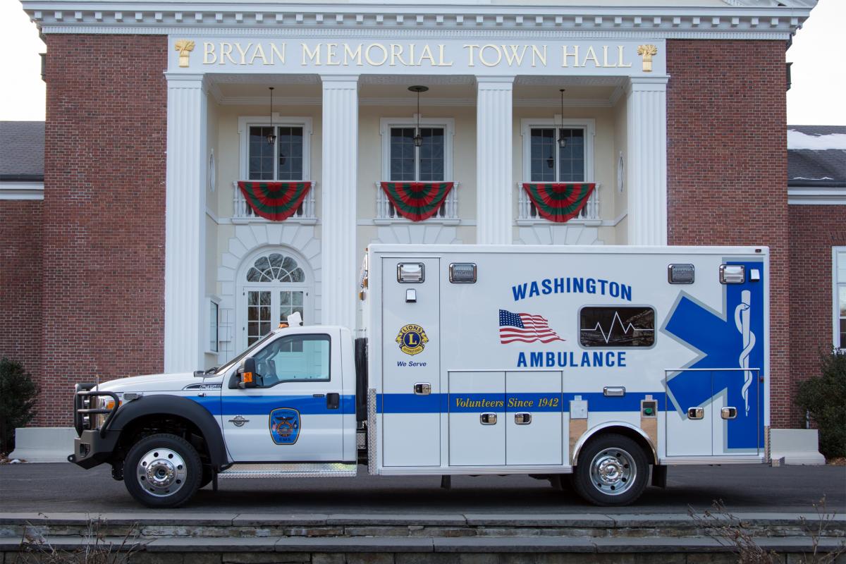 Ambulance outside of Town Hall (brick building with tall columns in front)