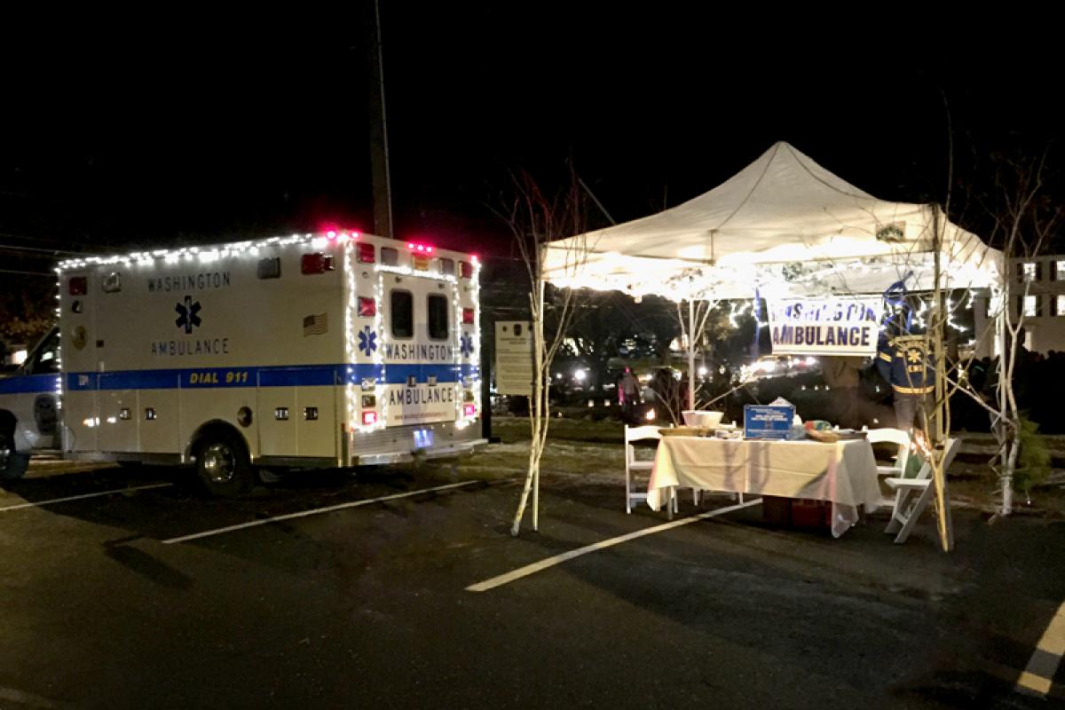 Our info tent and ambulance lit up for Holiday in the Depot 2014 - ambulance on left, tent on right, lighted from inside