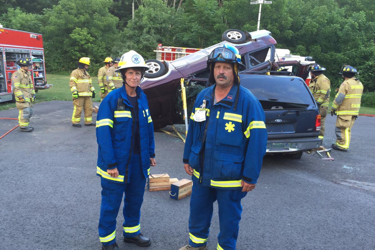 Extrication drill with WVFD June 2016 - man, woman posing in front of wrecked vehicles, other service personnel nearer vehiclesl