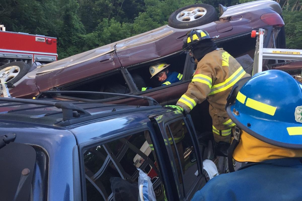 Extrication drill with WVFD June 2016 - 3 service personnel standing near and on wrecked vehicles