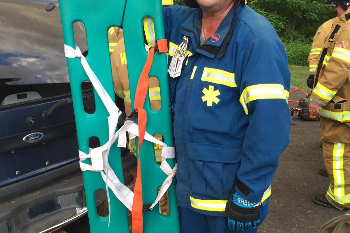 Extrication drill with WVFD June 2016 - Man facing camera holding board for transporting people