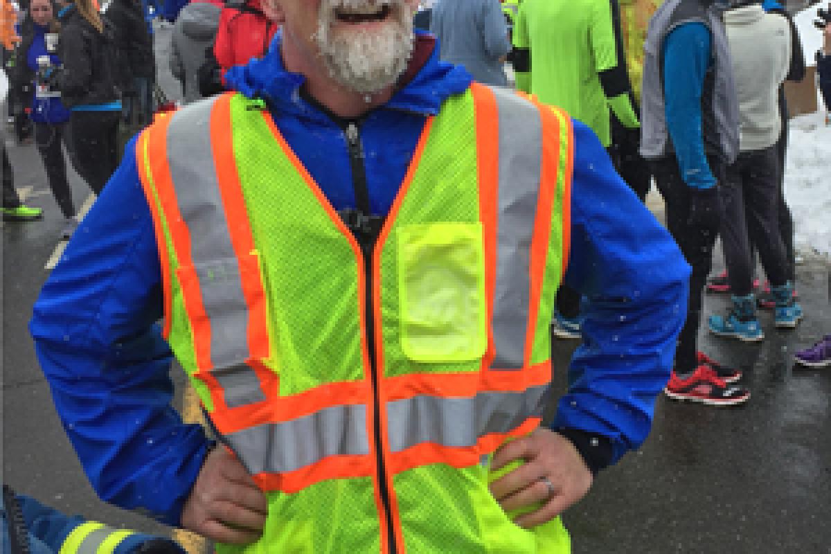 Polar Bear Run standby 2015 - EMS 31 ran the course - Smiling man standing in bright, reflective vest, hands on hips