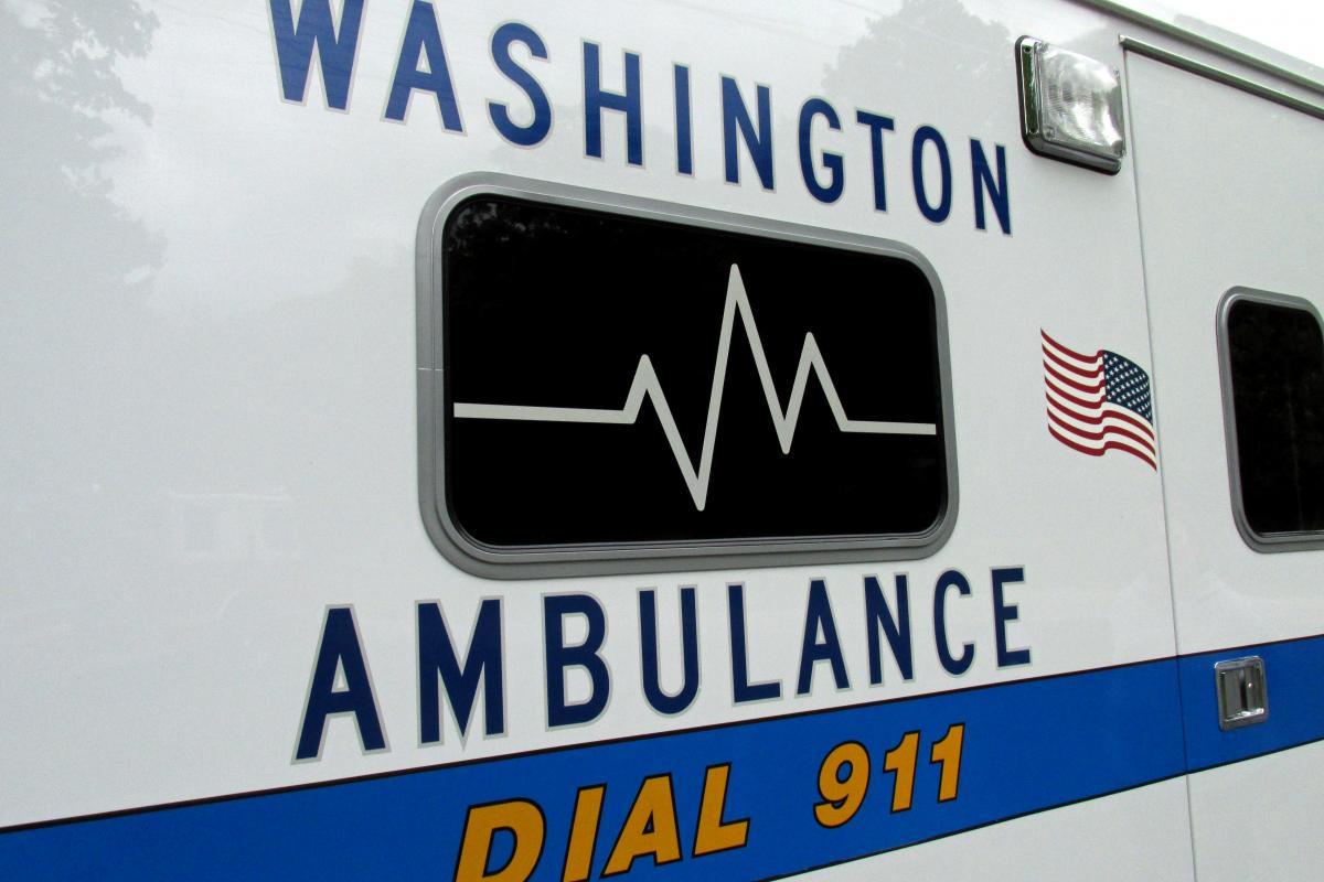 Photo of Side of mondern Ambuland with words "Washington Abmbulance Dial 911) and image of electrocardiogram